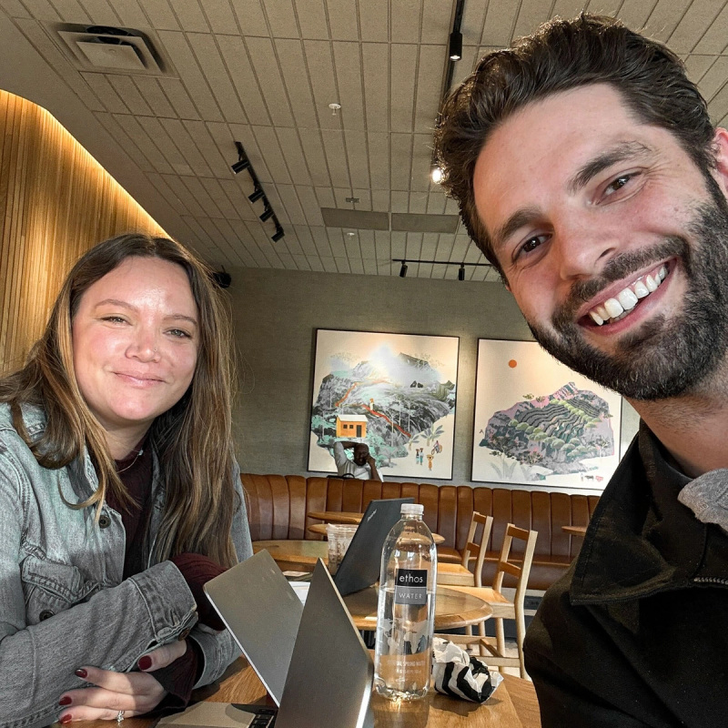 2 smiling employees at a coffee shop