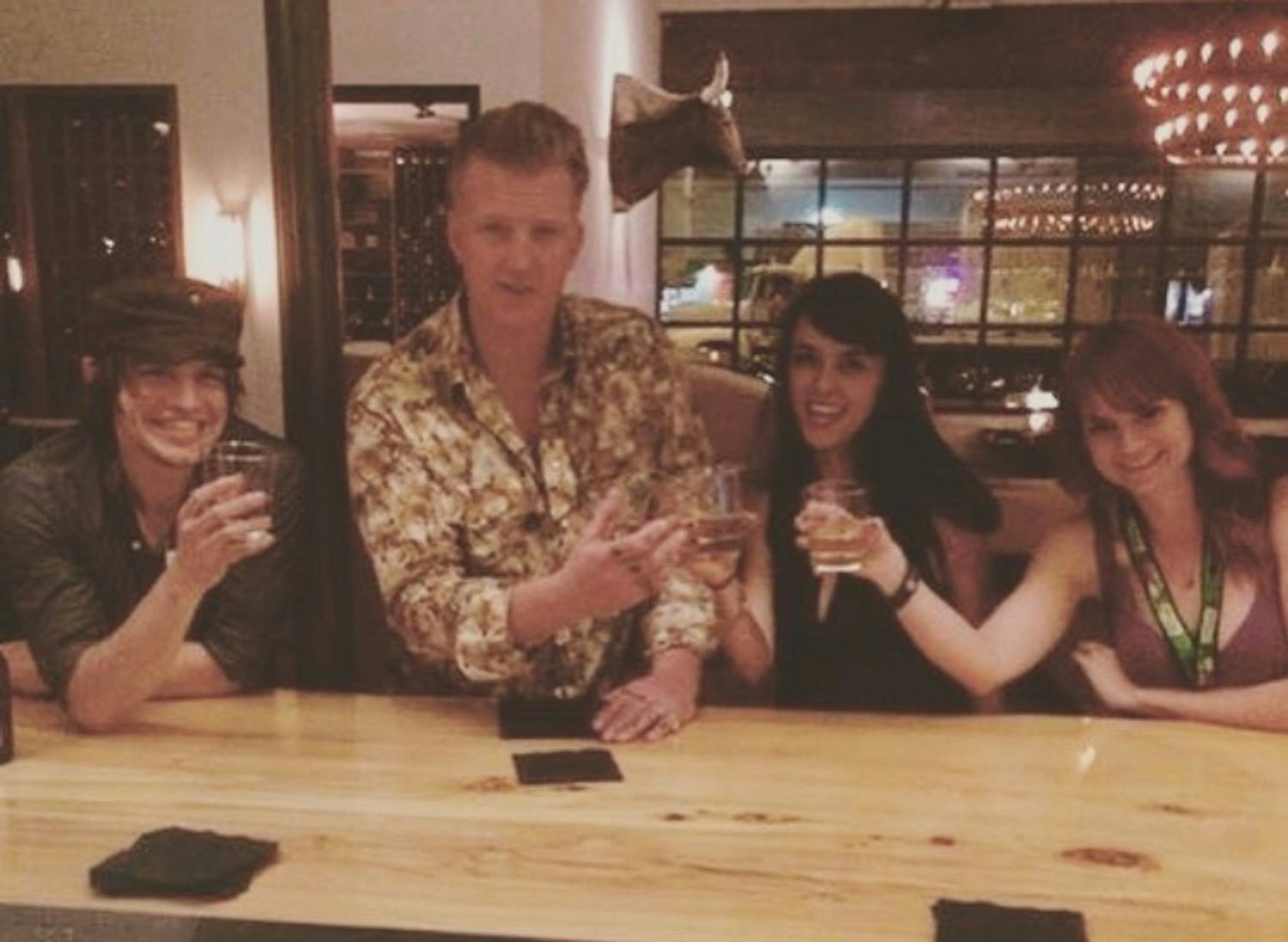 Jared poses with Josh Homme as they "cheers" their tequila shots.