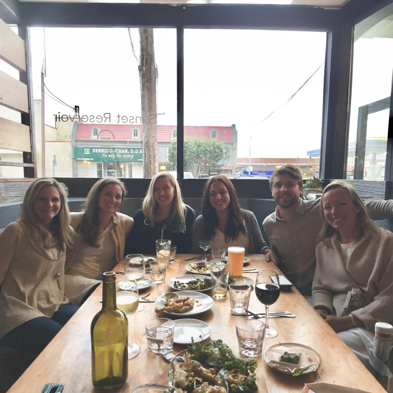 A group of employees at a restaurant table. 